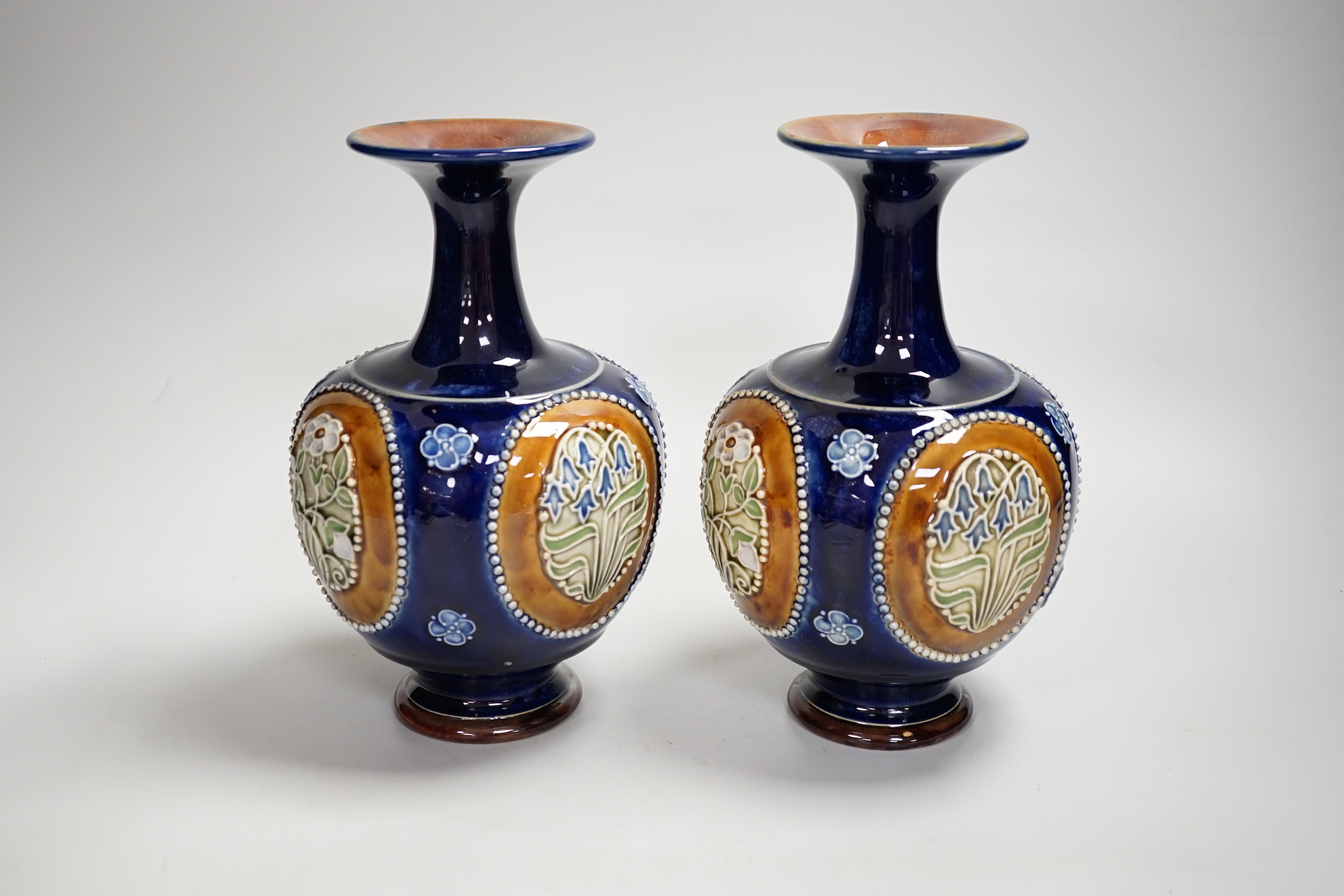 A pair of Royal Doulton vases, 22cm high